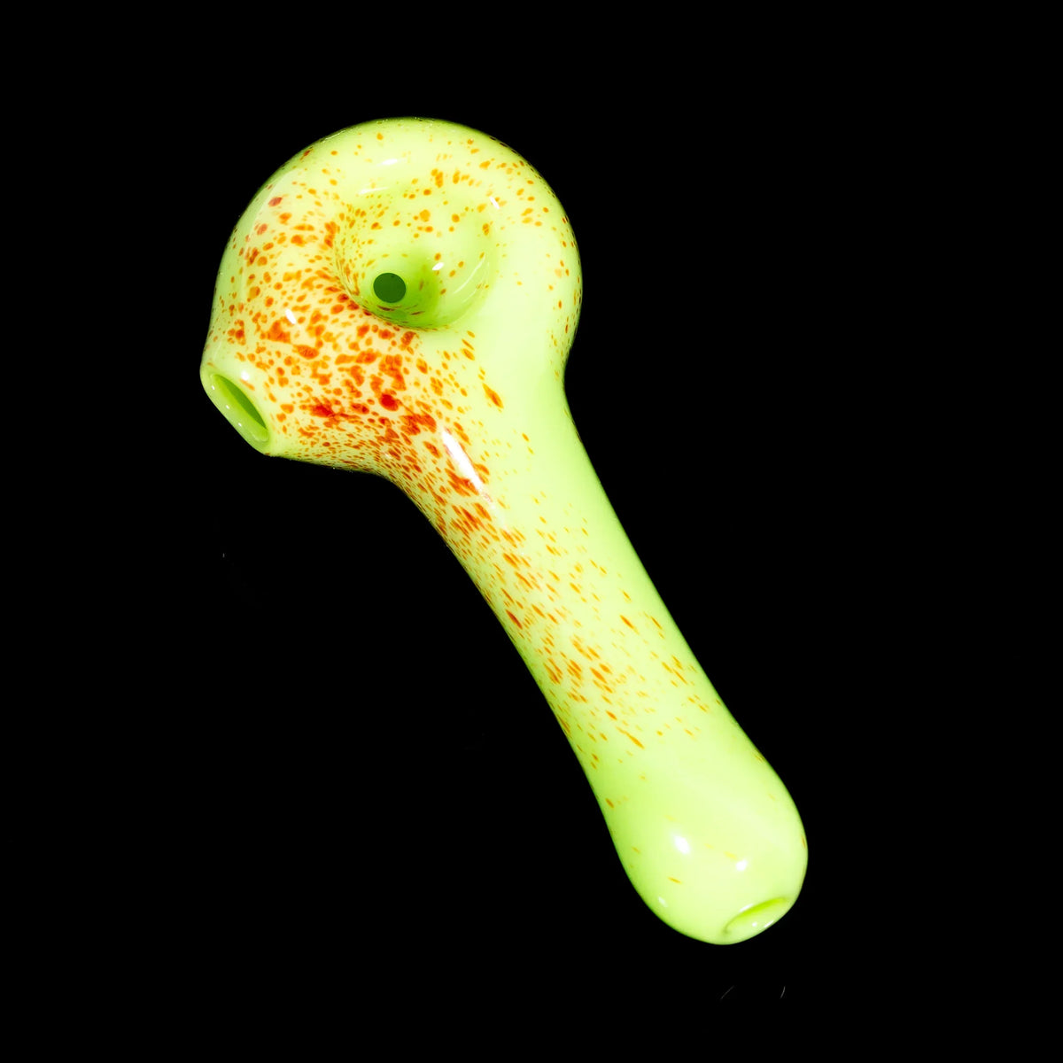 Yellow glass hand pipe with red splatter design on black background