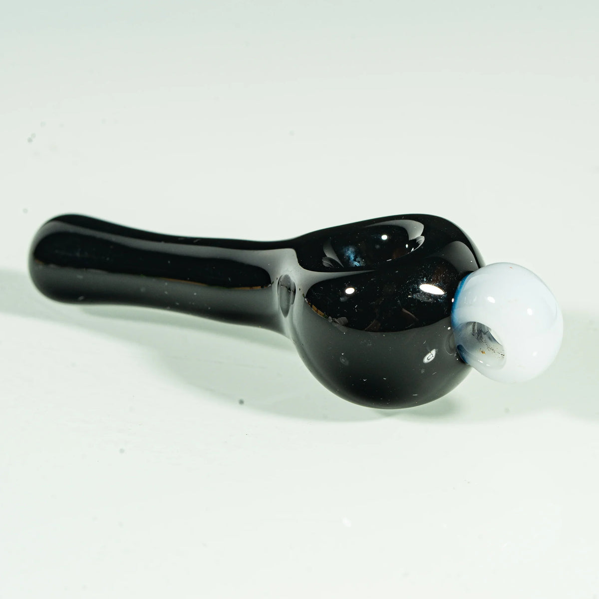 Black glass hand pipe with a white galaxy-inspired glass accent on the bowl