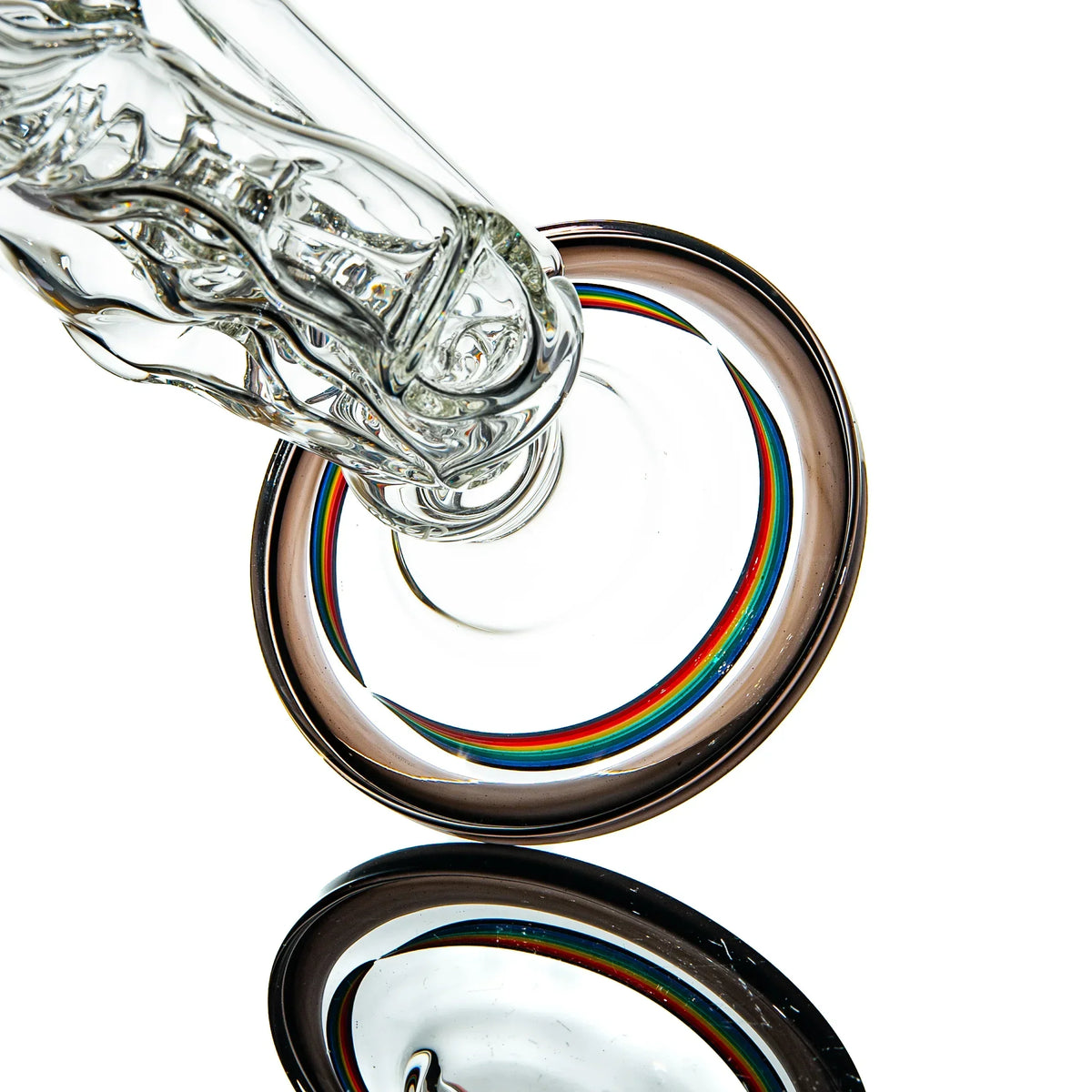 Close-up of a clear glass bong base with colorful rainbow accents on white background