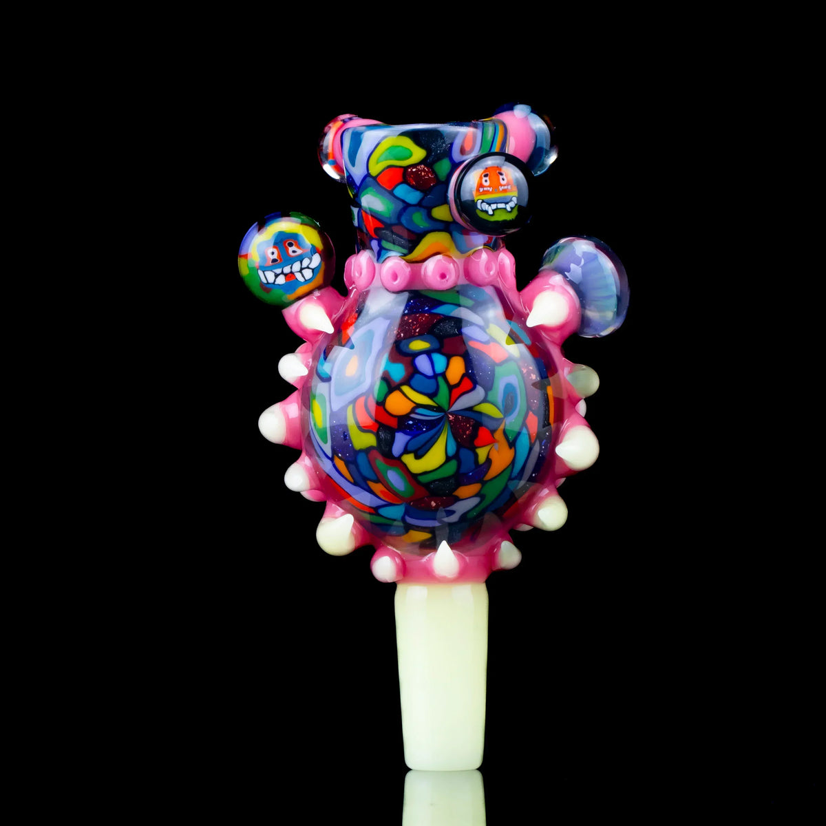 Colorful 14mm three-hole glass slide with intricate patterns and raised accents on black background