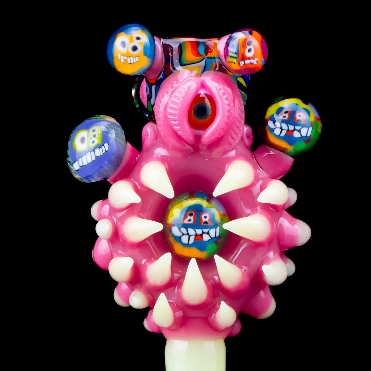 Colorful pink glass pipe slide with eye design, spikes, and vibrant cartoon faces, 14mm size.