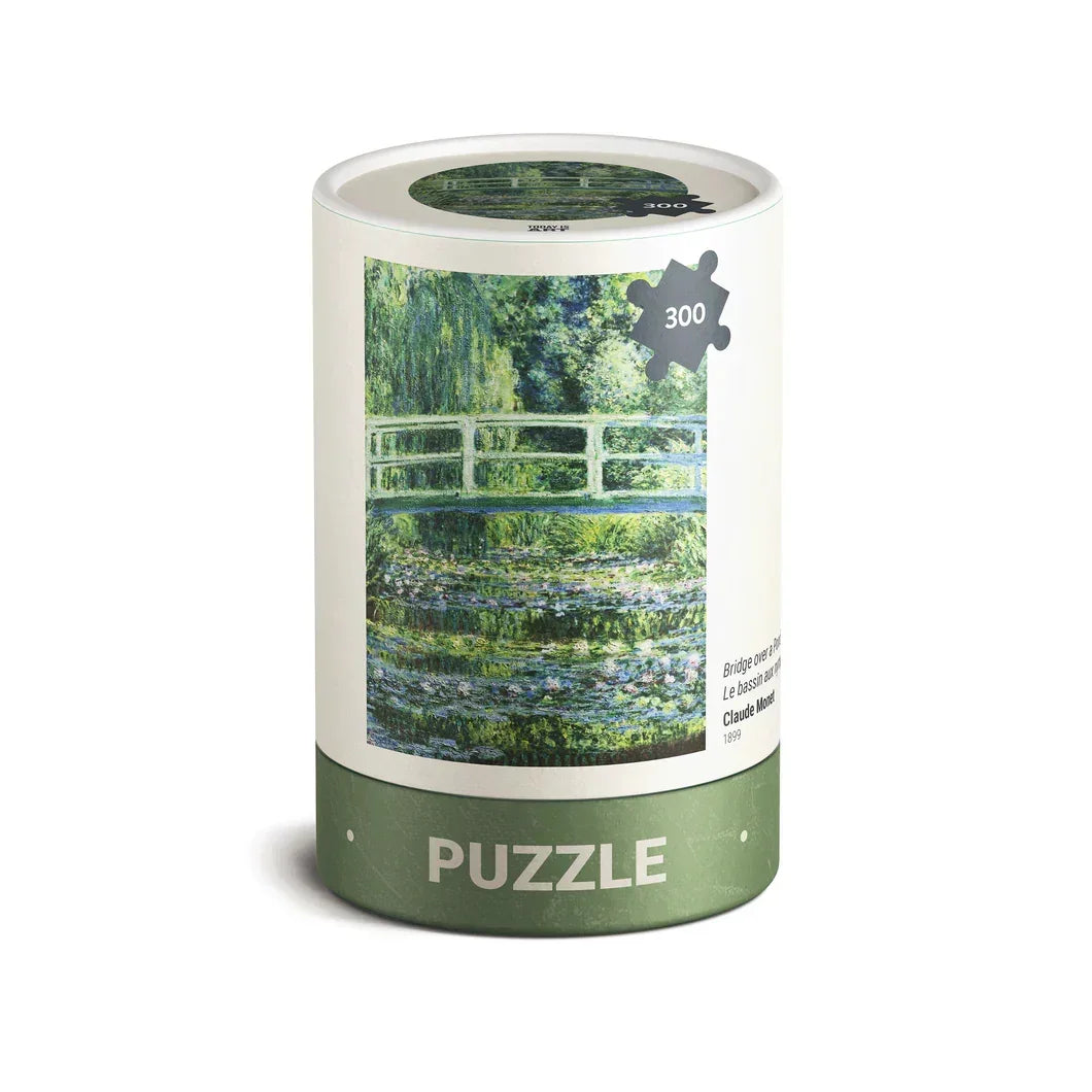 300 piece puzzle in a cylinder box featuring Monet's Japanese bridge painting on the label