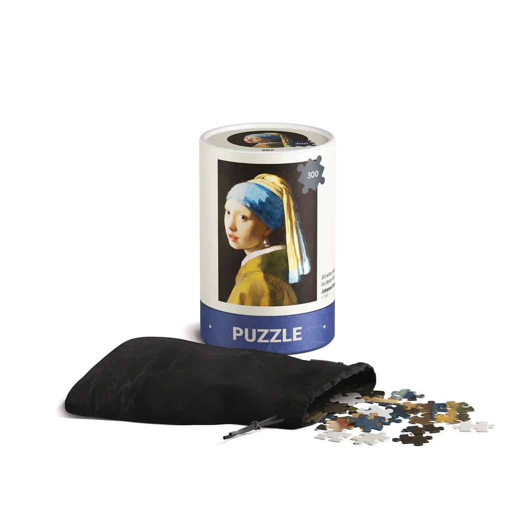 300-piece art puzzle in cylindrical box featuring Girl with a Pearl Earring painting, pieces in pouch