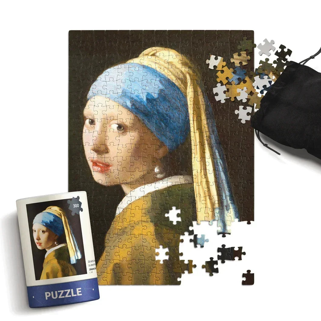 Girl with a Pearl Earring art jigsaw puzzle with loose pieces and storage bag.