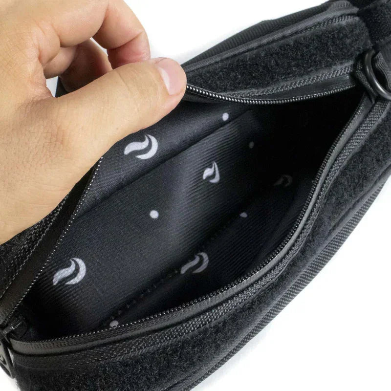 Hand opening black zippered travel pouch with patterned interior lining
