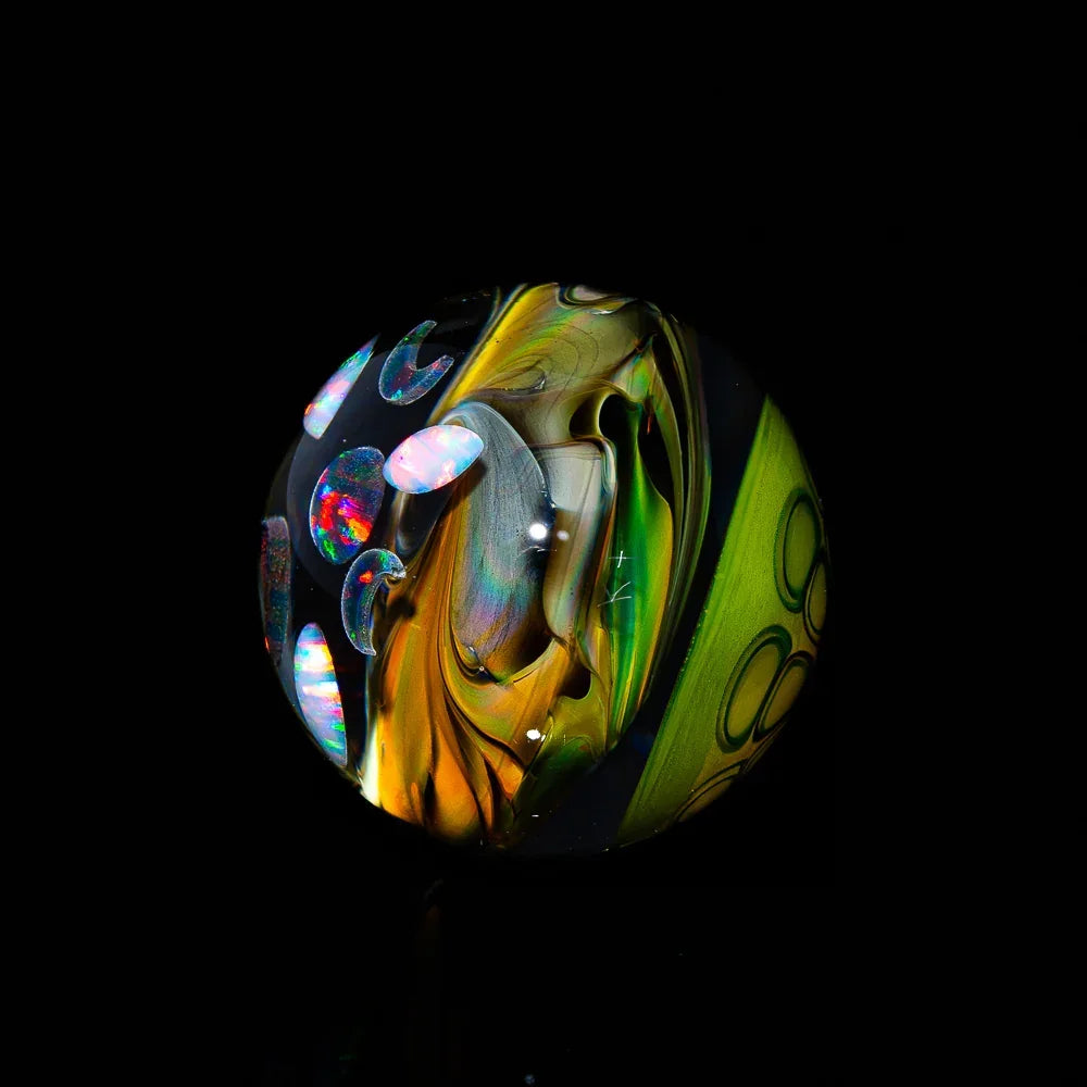 Heady glass marble with colorful swirls and opal accents on a black background