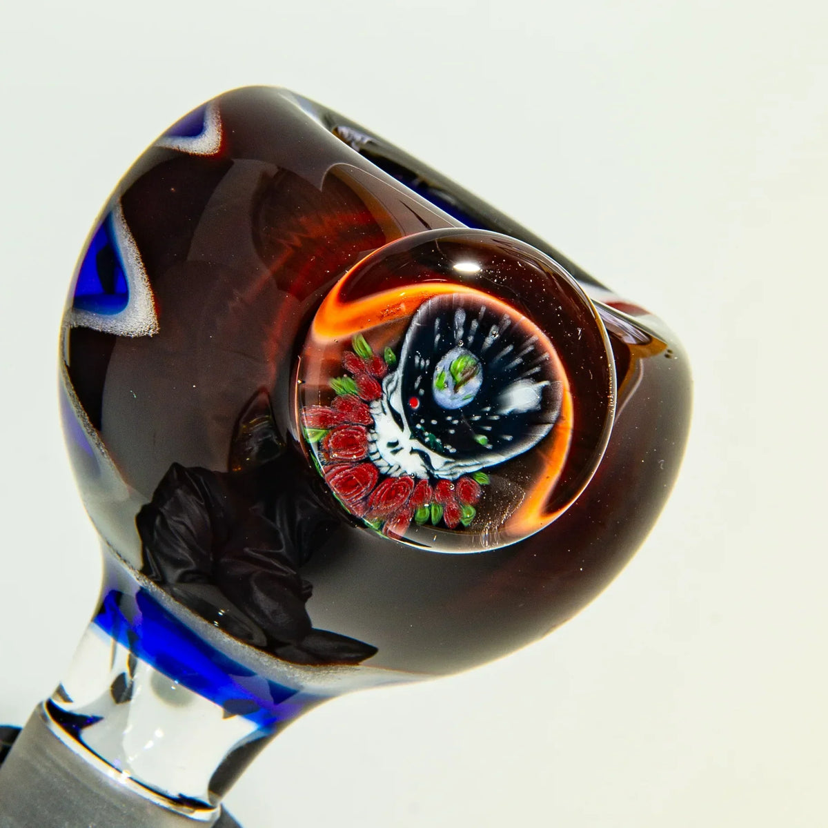 Heady glass bowl with colorful galaxy marble and blue accents, artisan glass pipe closeup