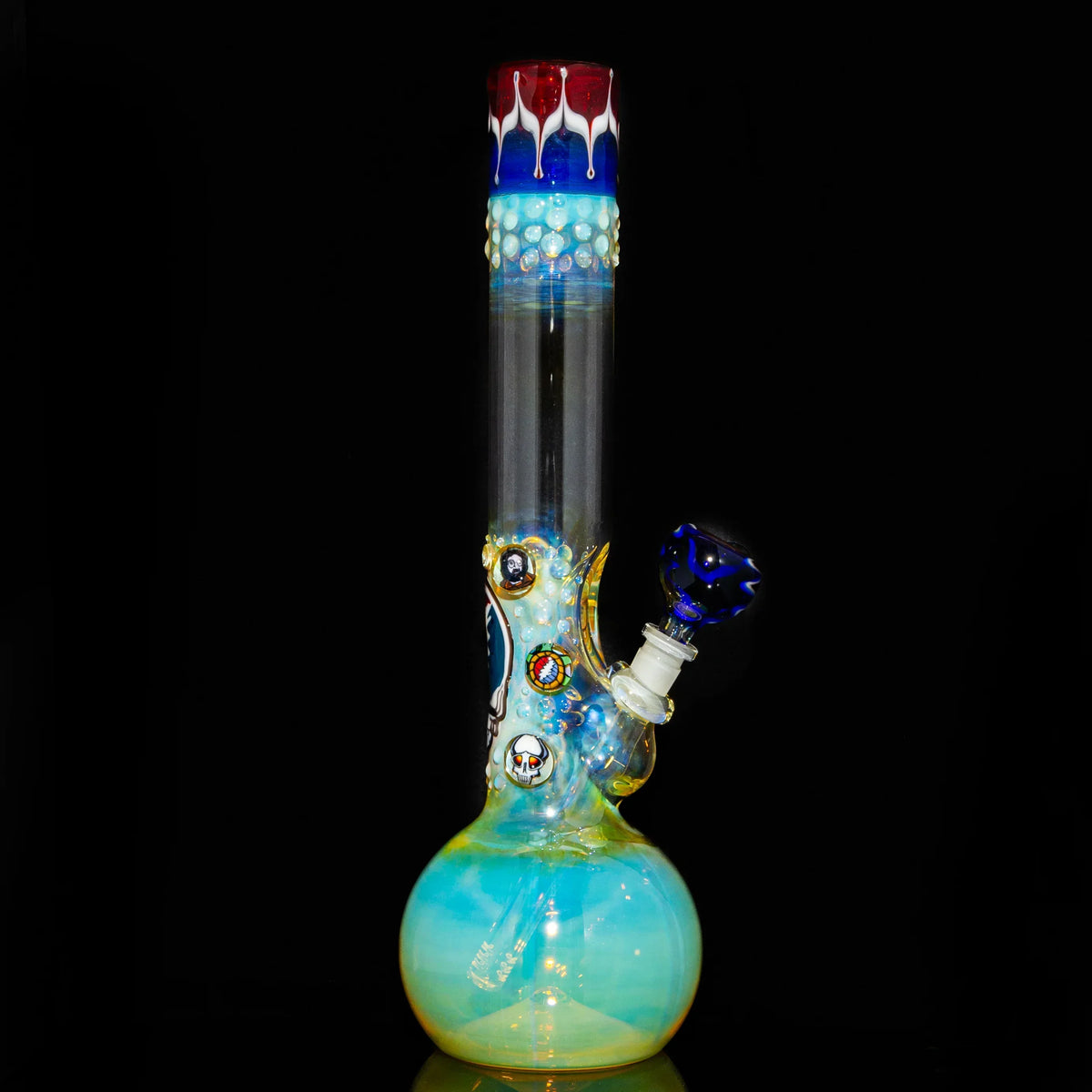 Fumed glass bong with colorful accents and decorative marbles on a black background