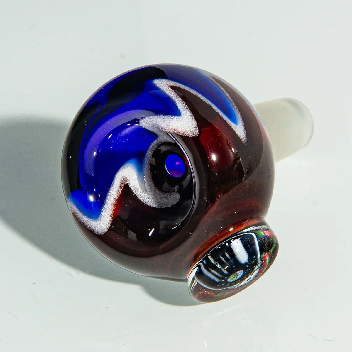 Colorful glass bong slide with swirled blue, white, and red patterns on a white background