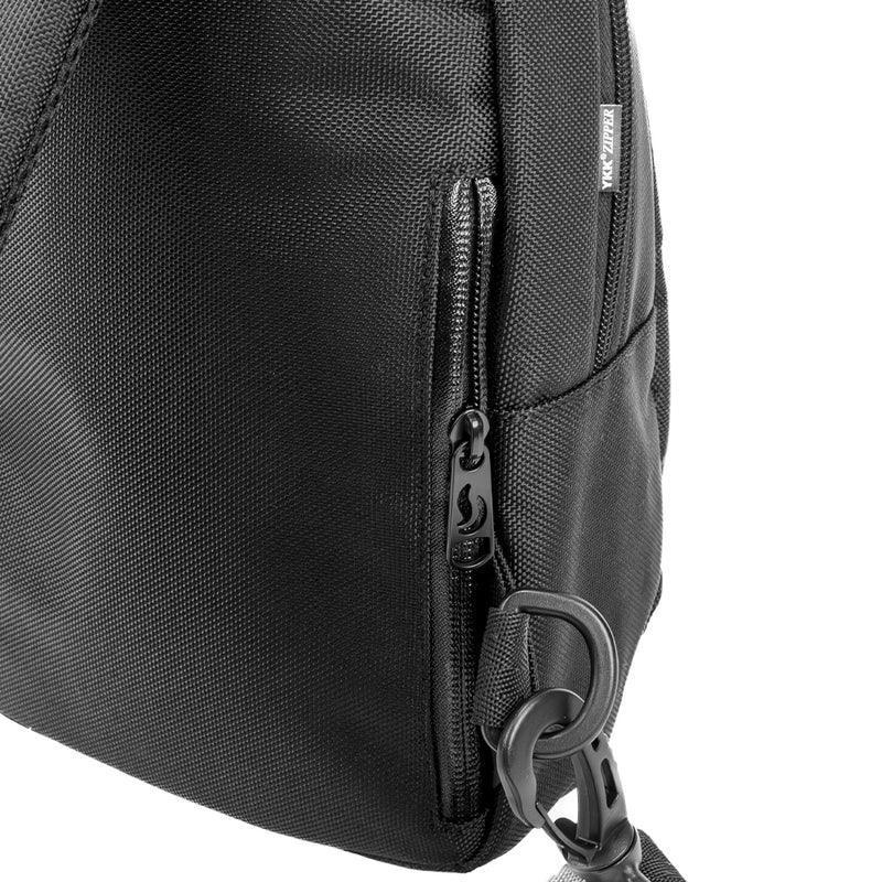 Closeup of black smell-proof sling bag with zipper pocket and durable strap clip