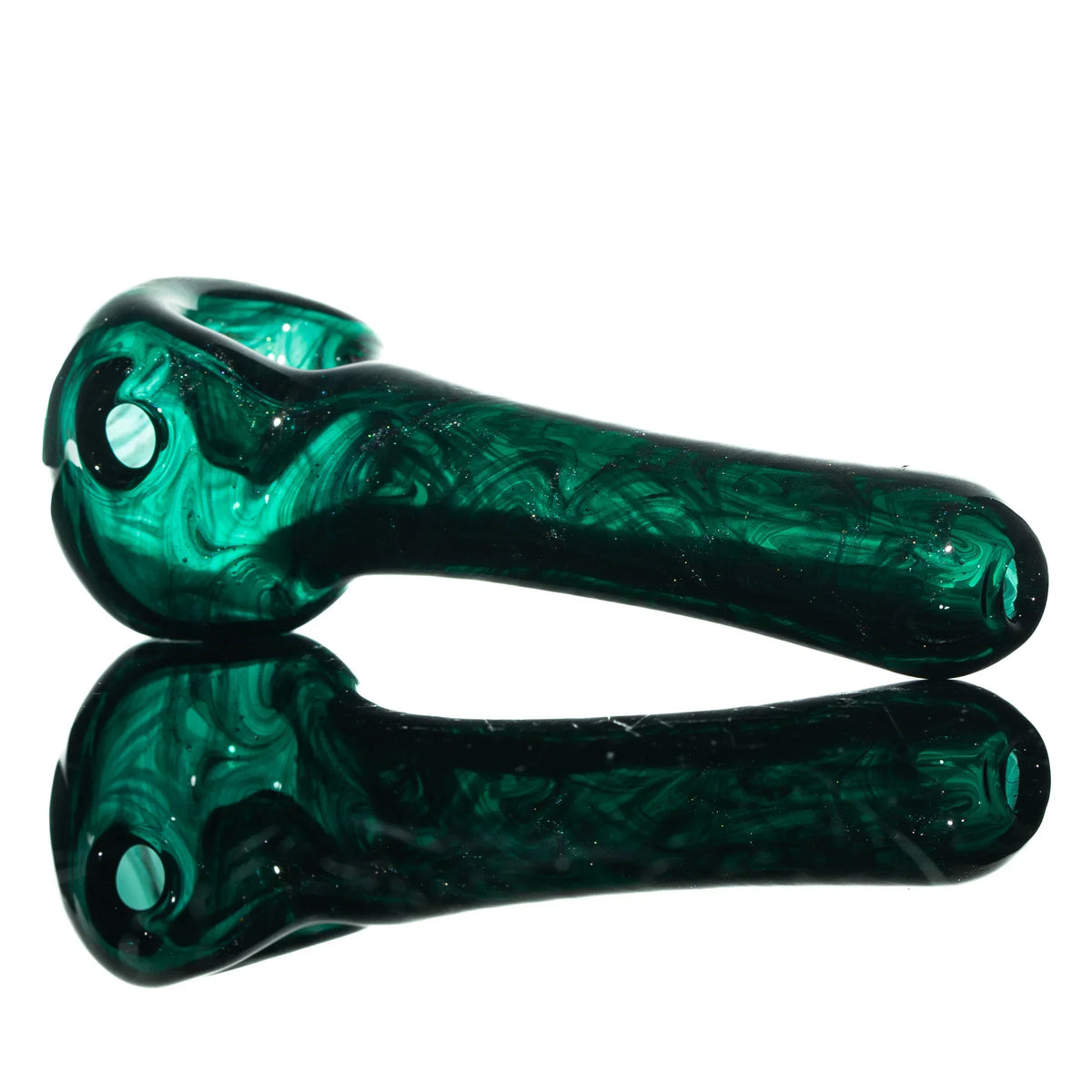 Green glass hand pipe with swirling patterns on a reflective surface