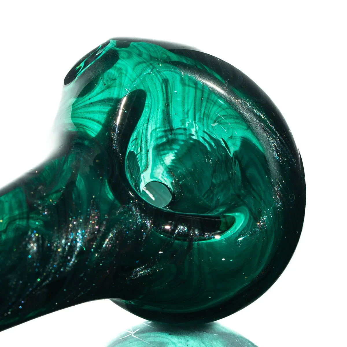 Close-up of a green glass hand pipe with swirling patterns and deep bowl