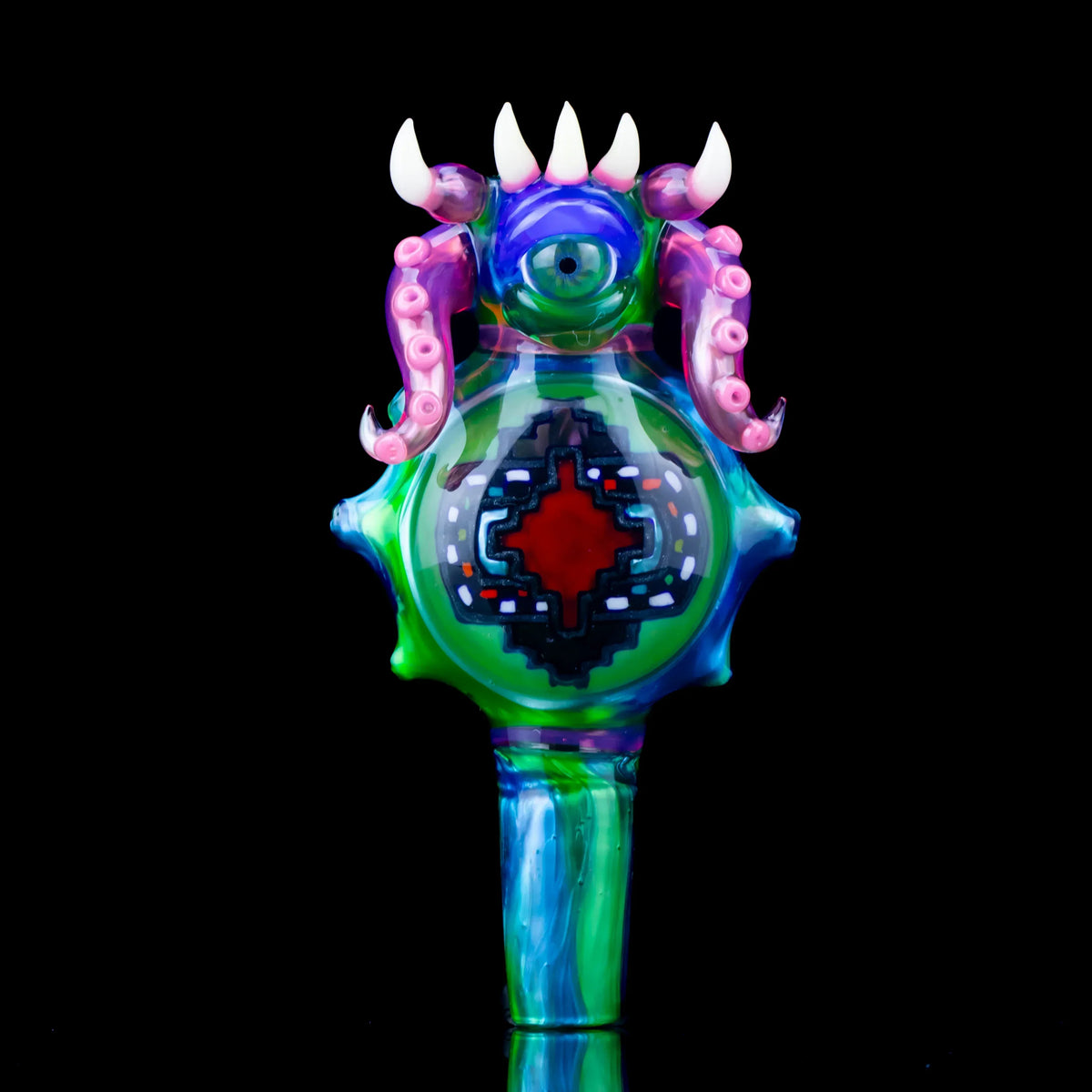 Colorful glass slide with monster design, featuring horns, tentacles, and an 18mm joint