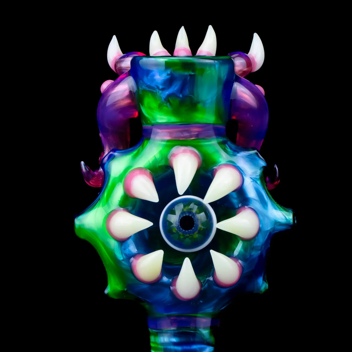 Colorful 18mm glass slide with three holes, spiked design, blue and green accents, on black background.