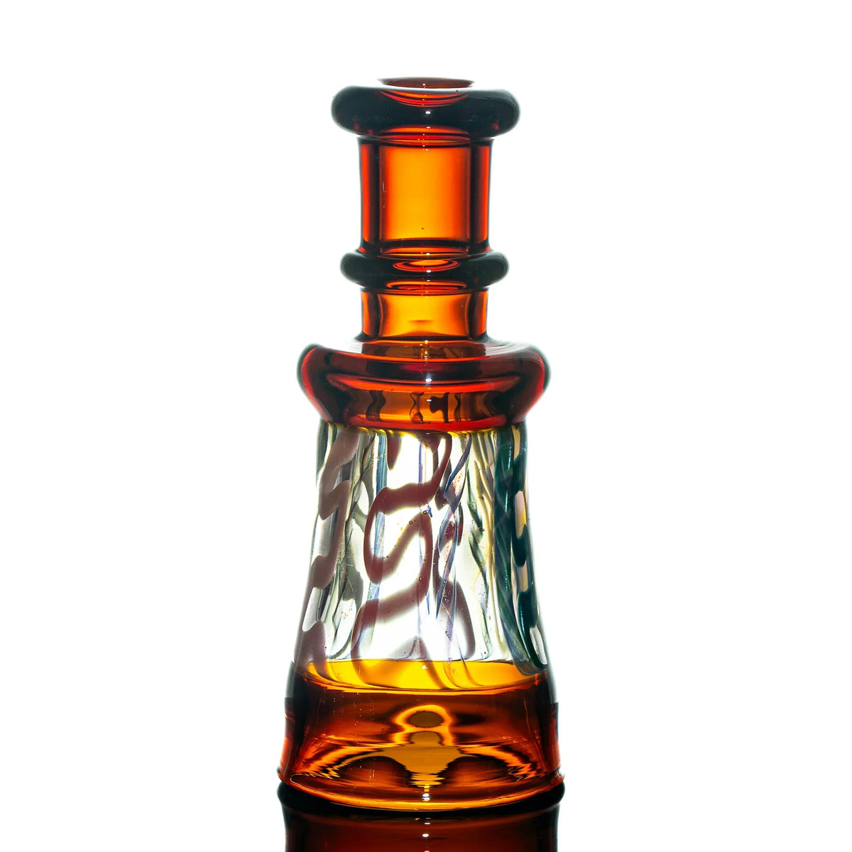 Amber and clear heady glass water pipe with artistic swirling design, isolated on white