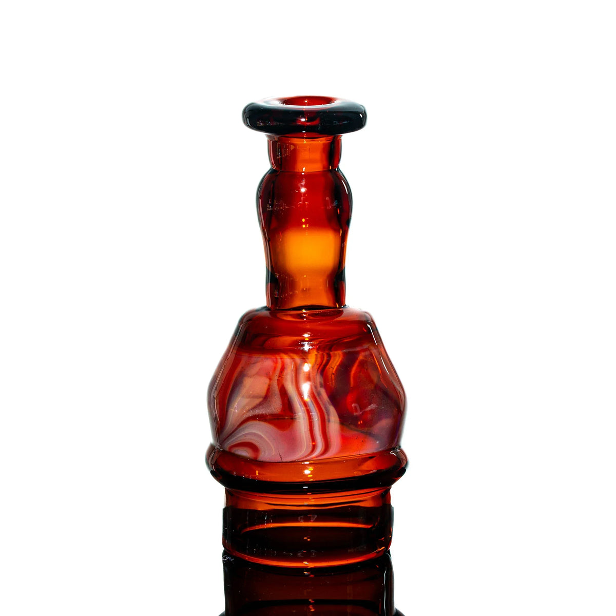 Handblown red glass water pipe with marbled design on a white background