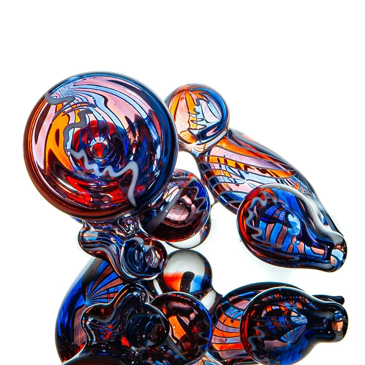 Colorful heady glass pipe with intricate red, blue, and orange patterns on white background