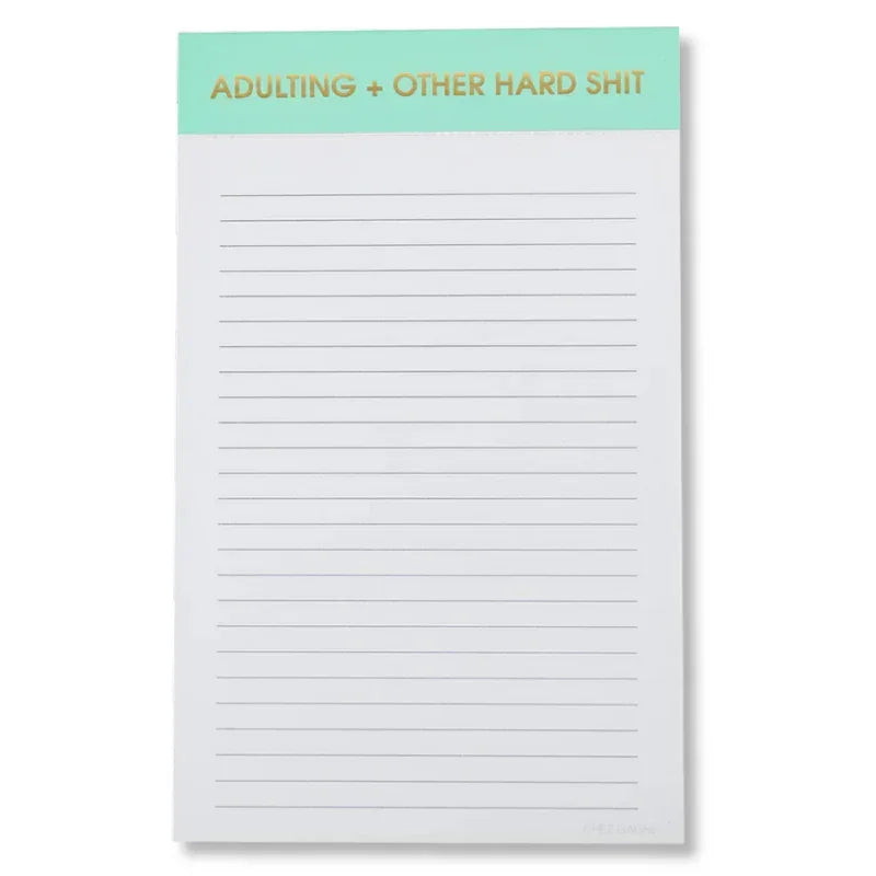 Lined notepad with mint green header labeled 'Adulting + Other Hard Shit' in gold letters.