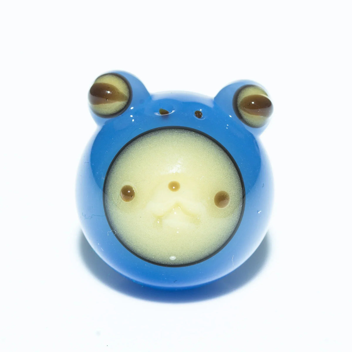 Blue glass frog carb cap with detailed face and bulging eyes on white background