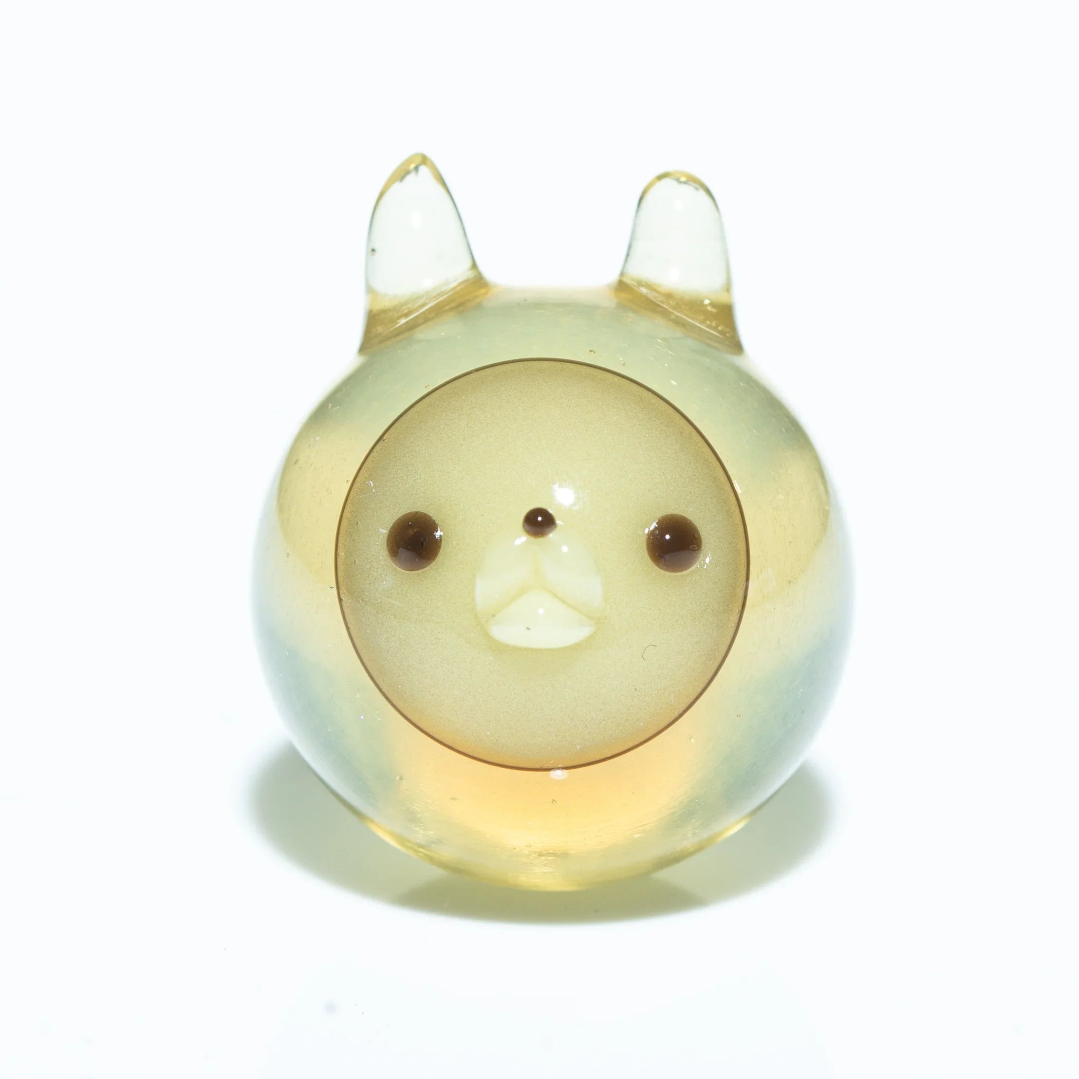 Round glass carb cap shaped like a cute animal with ears on a white background