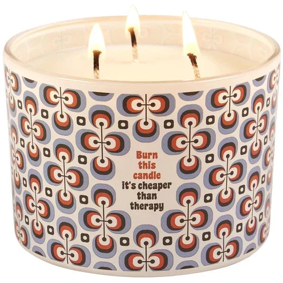 Retro patterned three-wick candle with text 'Burn this candle it’s cheaper than therapy'.