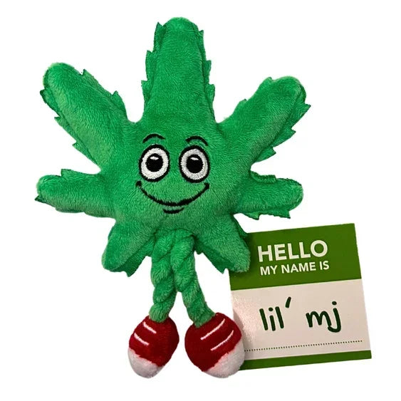 Plush toy shaped like a green leaf with cartoon eyes, red shoes, and a name tag reading 'lil' mj'.