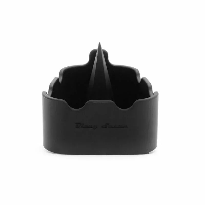 Matte black silicone ashtray with scalloped rim and center spike on white background