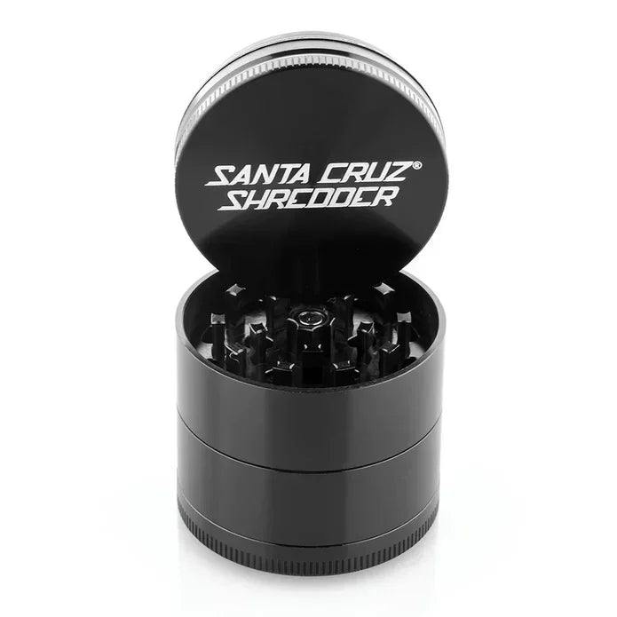 Black Santa Cruz Shredder herb grinder with open lid, metal teeth visible, isolated on white