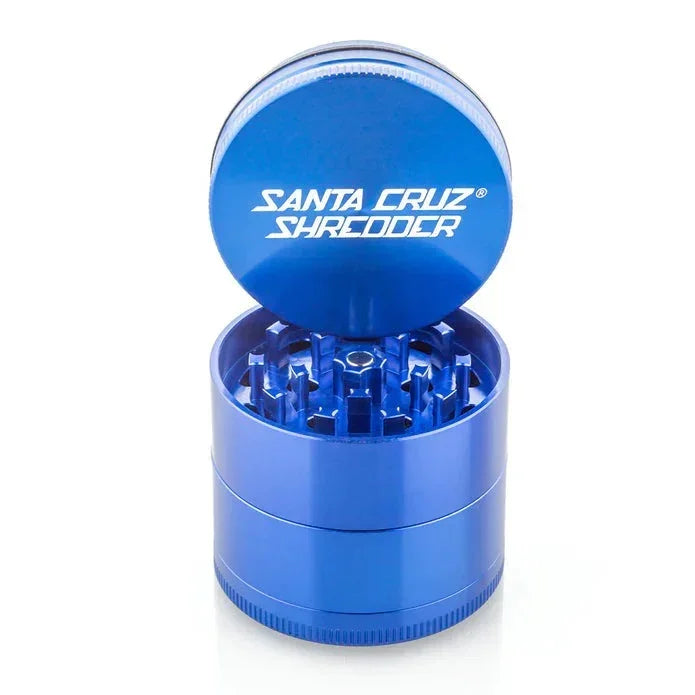 Blue Santa Cruz Shredder metal herb grinder with open lid, sharp teeth visible