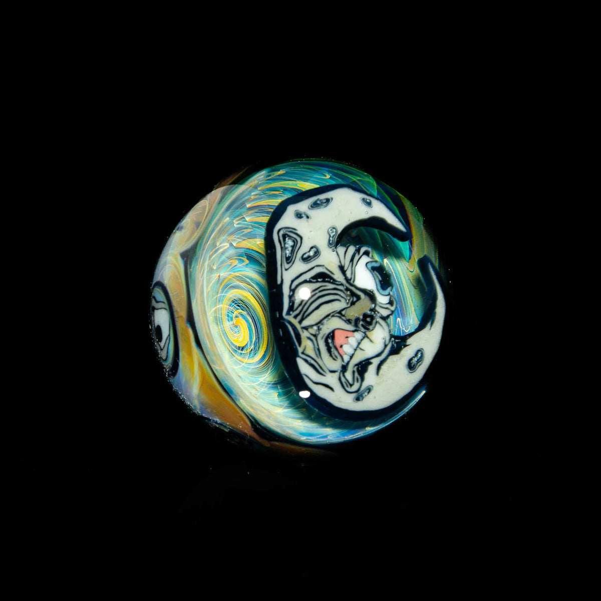 Heady glass marble with swirling colors and crescent moon face design on black background