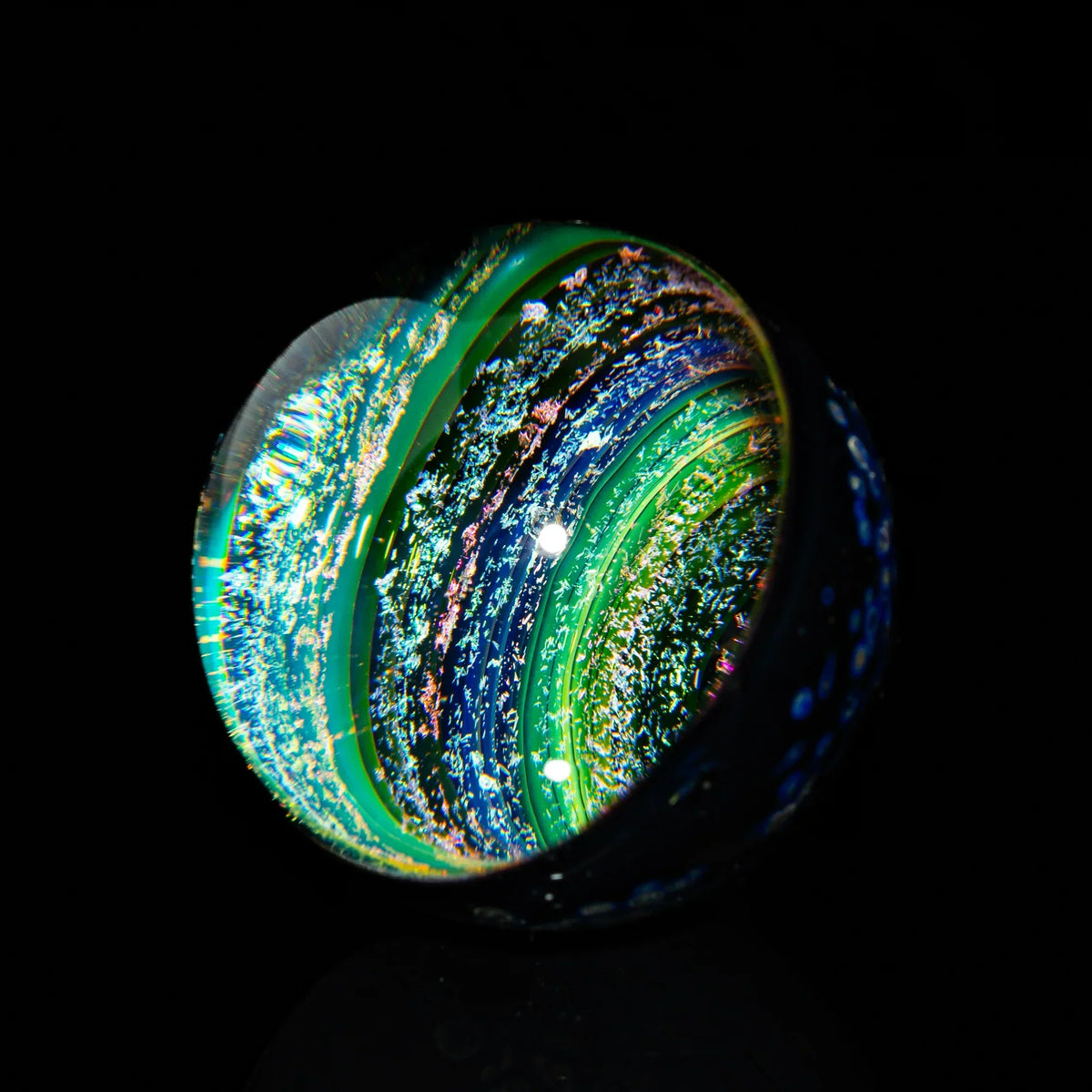 Heady glass marble with swirling blue, green, and iridescent galaxy-style patterns