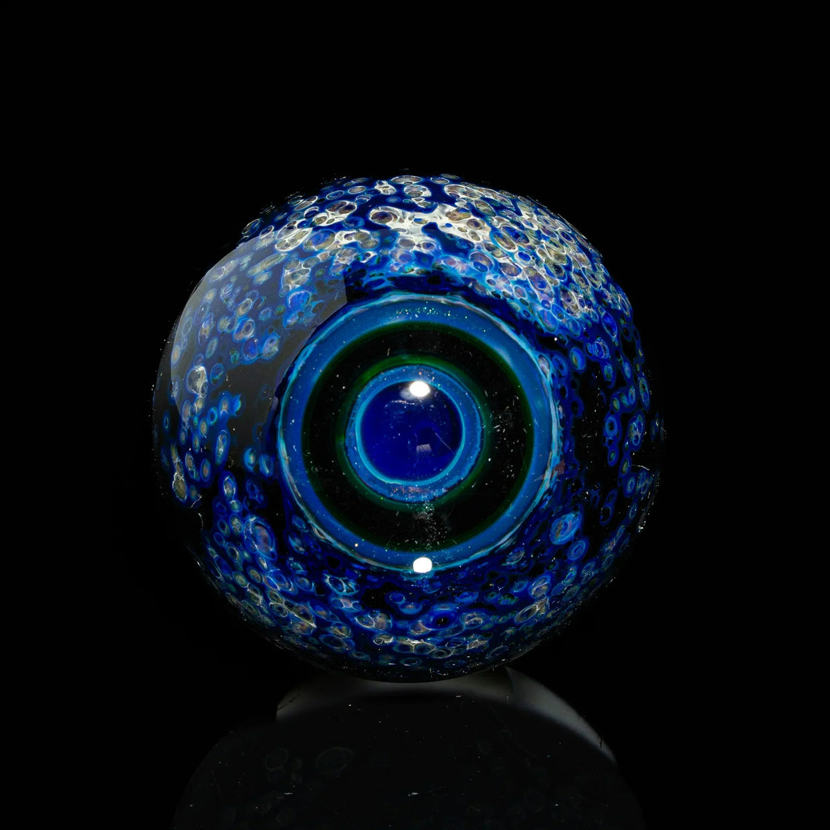 Handcrafted blue borosilicate glass marble with intricate bubble and swirl patterns