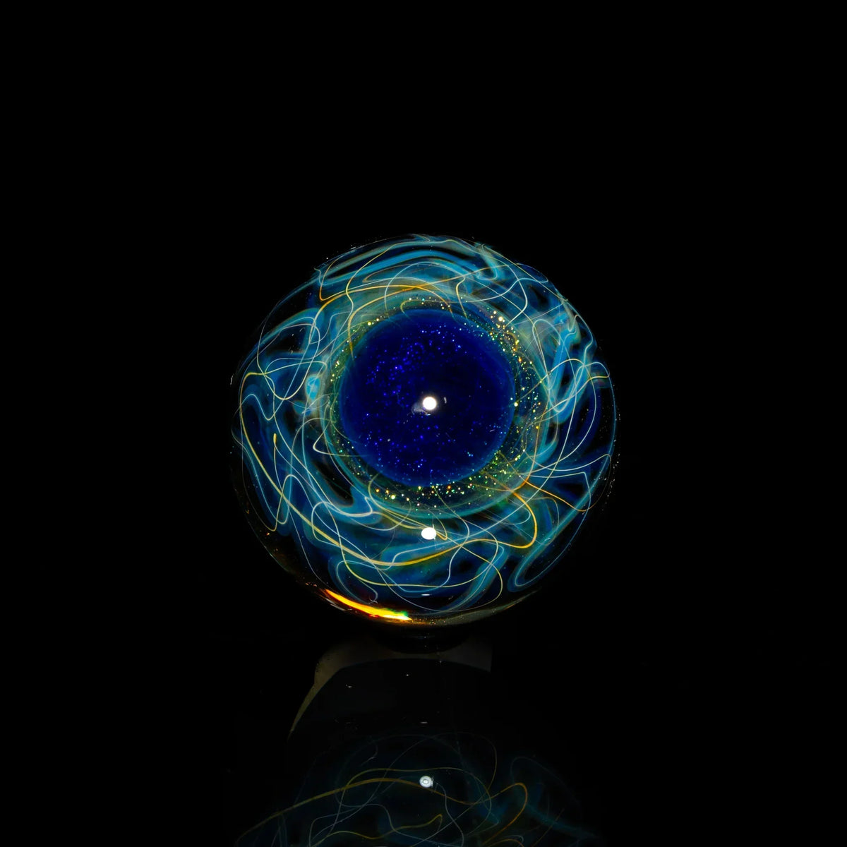 Heady glass marble with blue core and swirling yellow and white patterns on black background