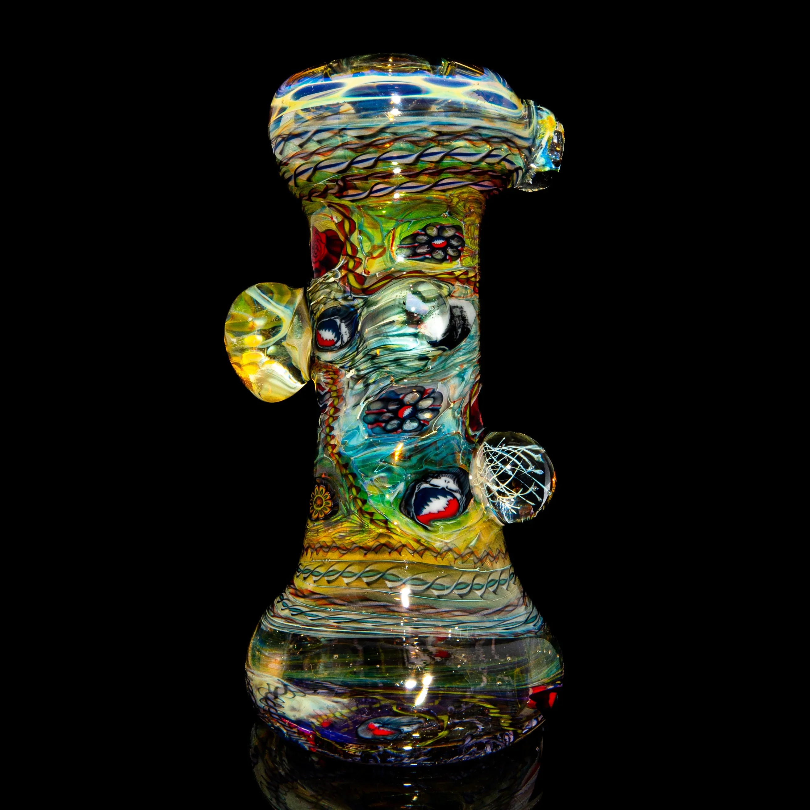 Colorful heady glass water pipe with intricate patterns on a black background
