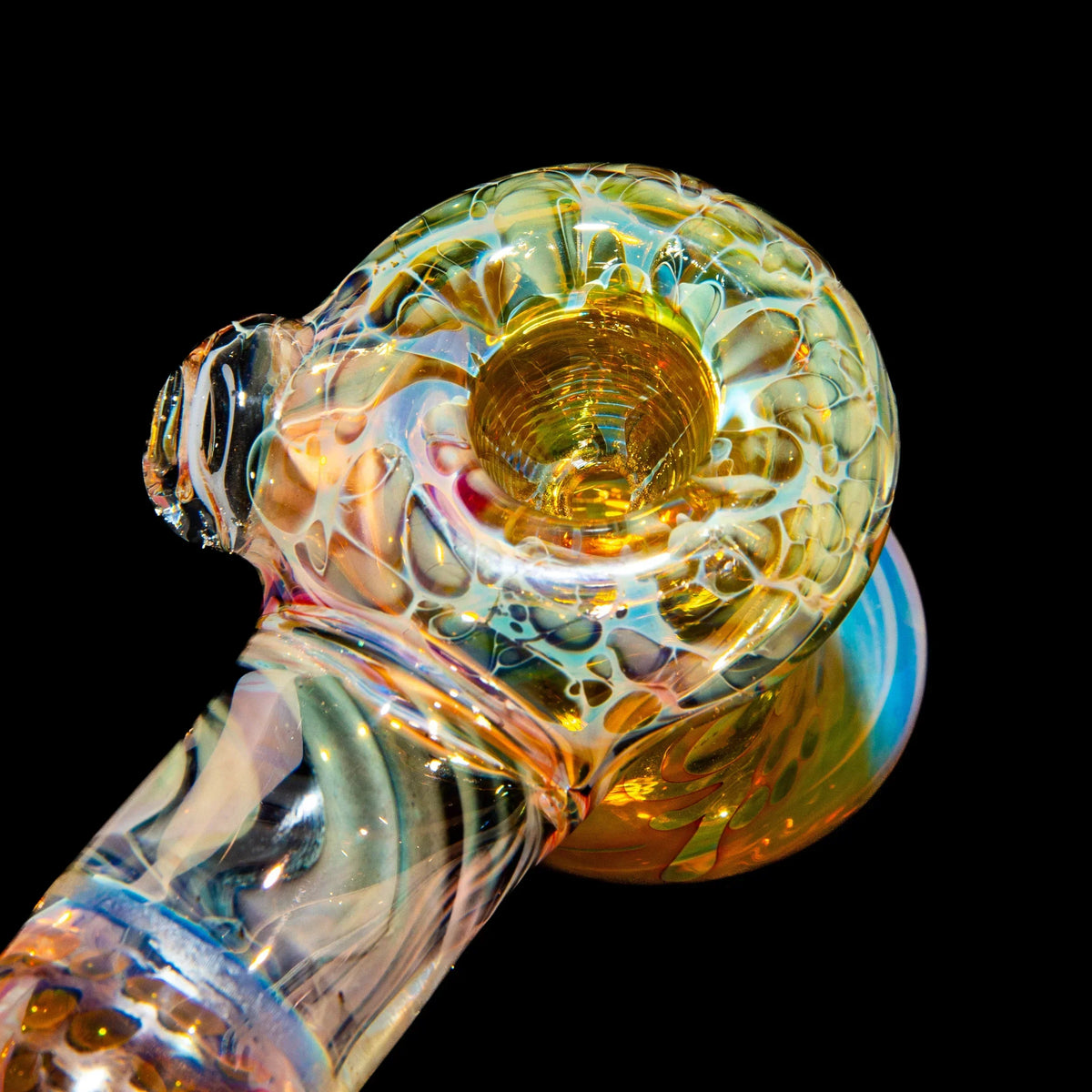 Colorful heady glass hand pipe with intricate patterns on black background