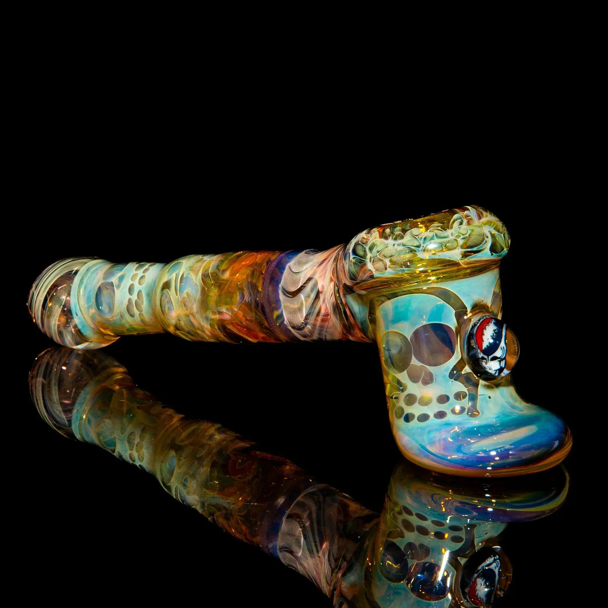 Heady glass hammer pipe with colorful swirls and unique design on black reflective surface