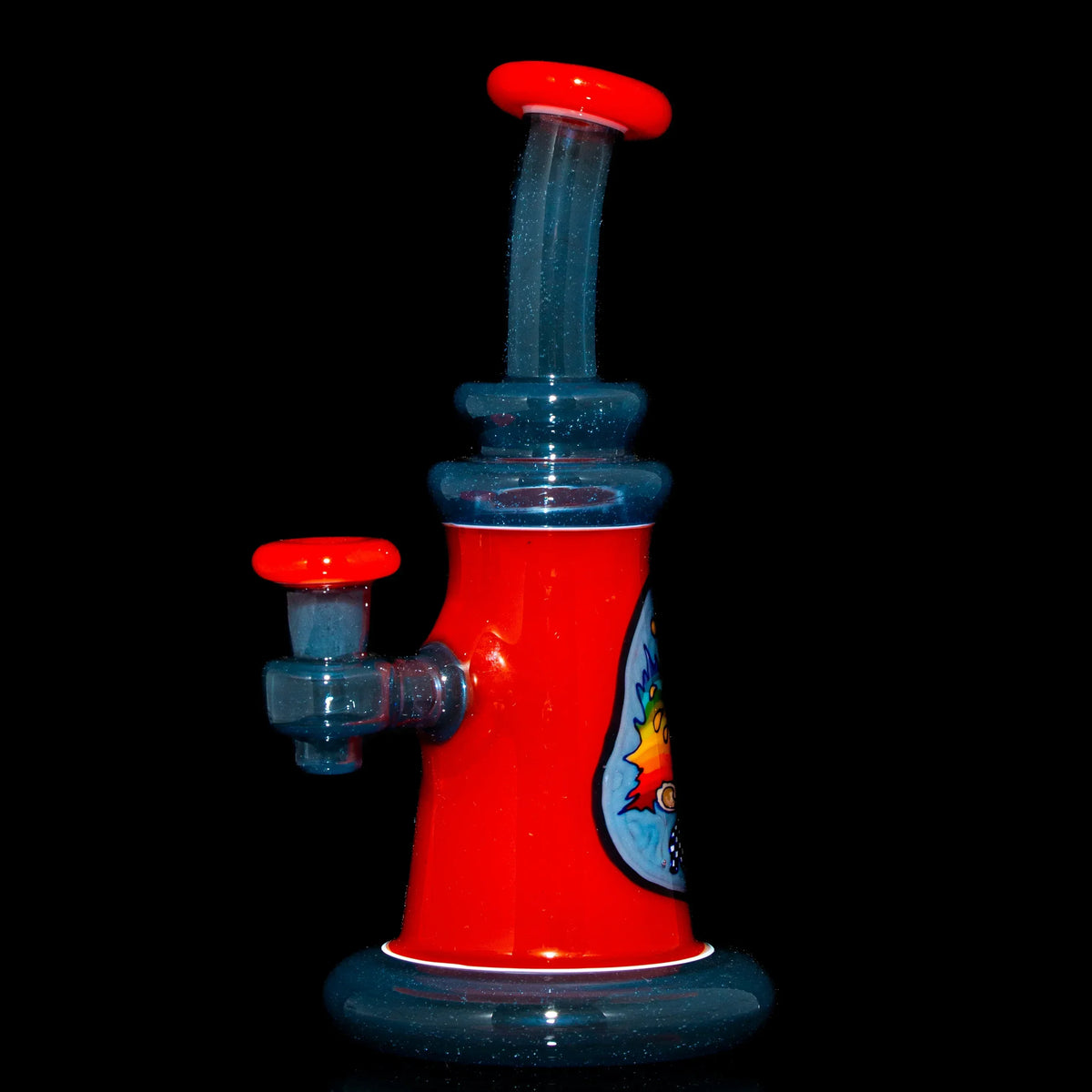 Red and blue glass water pipe with cartoon artwork and a flared mouthpiece on black background