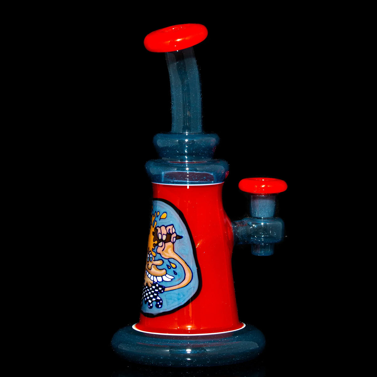 Artistic heady glass water pipe with red accents and cartoon design on black background.