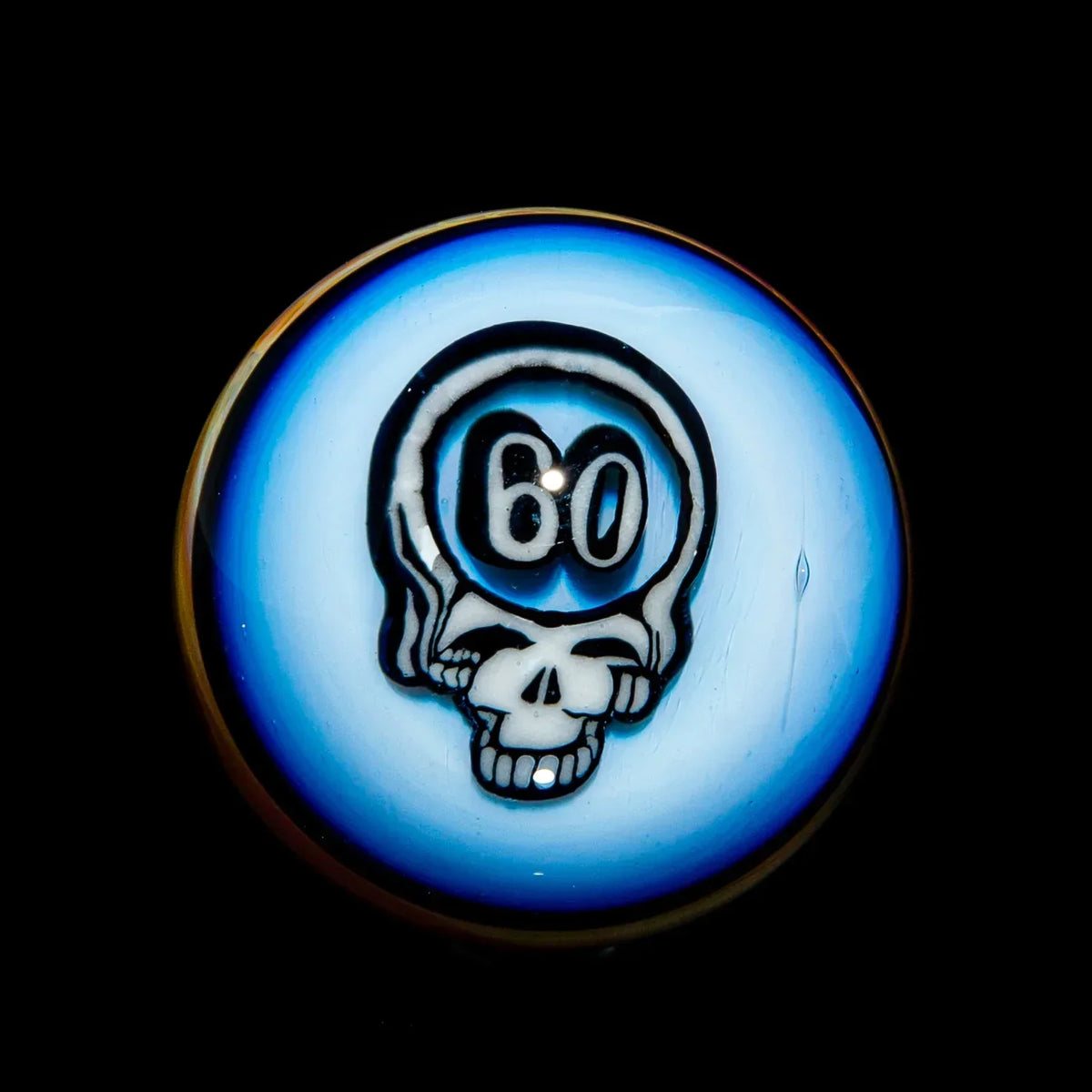 Detailed glass marble featuring a skull design with the number 60, blue background