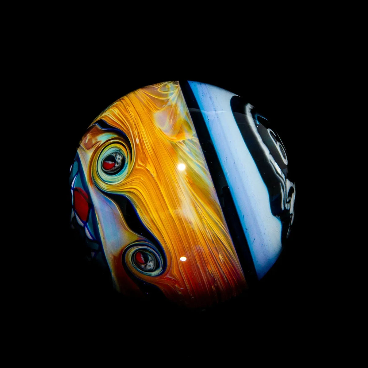 Heady glass marble with vibrant yellow swirls and abstract art details on a black background