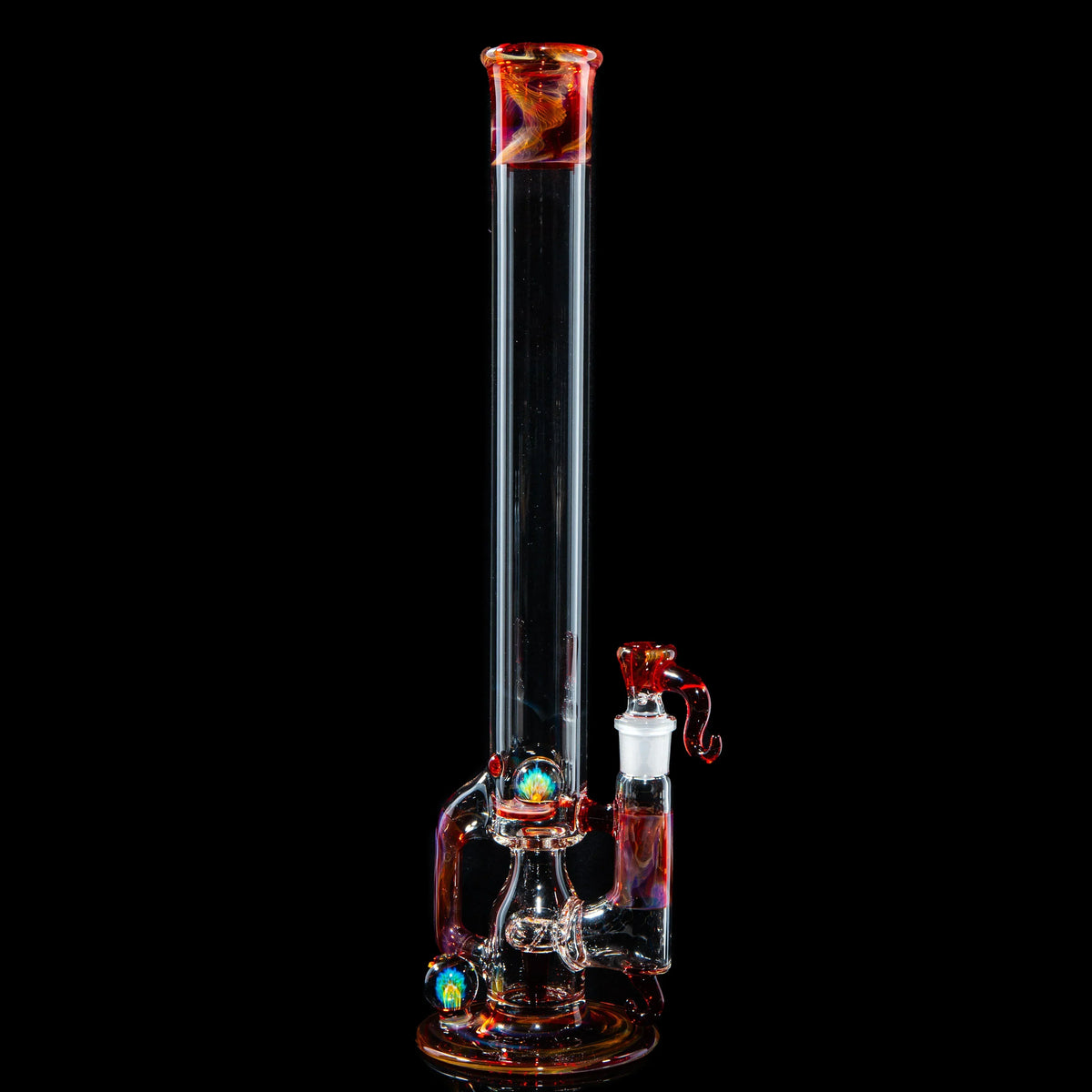 Heady glass bong with colorful accents and intricate marbles against a black background