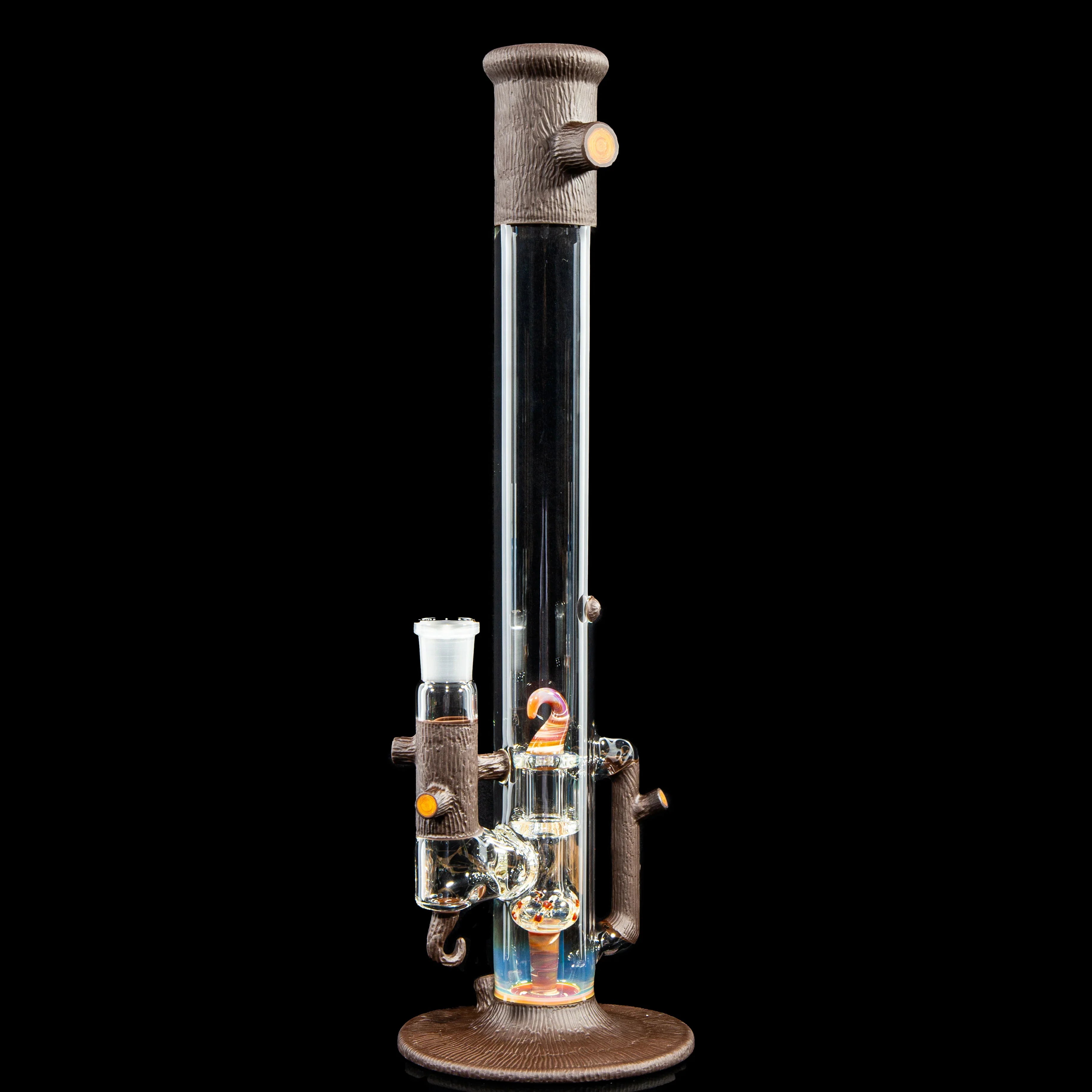 Artistic glass water pipe with wood-textured accents on a black background