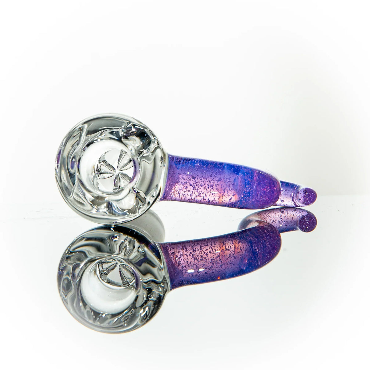Hand-blown purple glass pipe with clear bowl and reflective surface