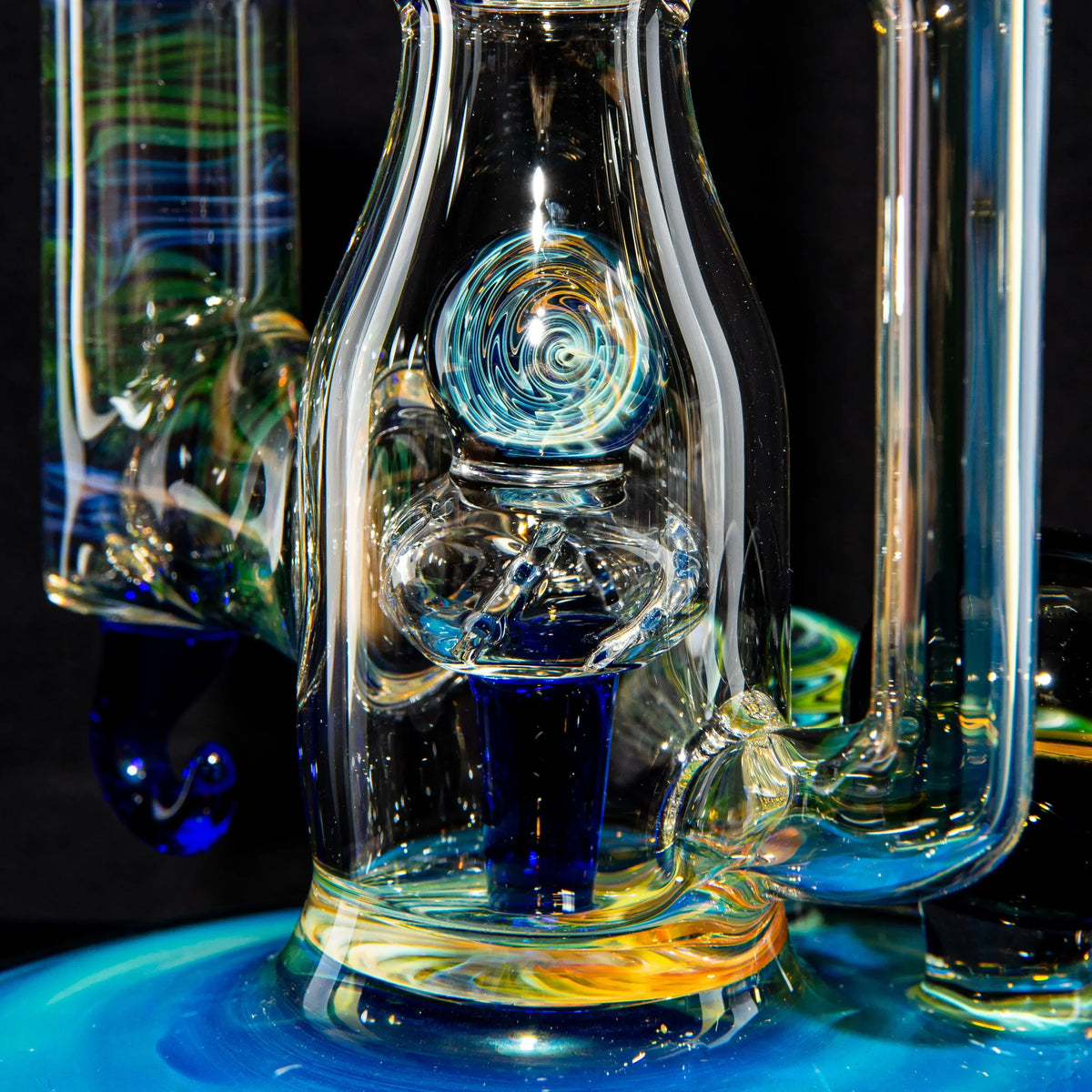 Intricate heady glass water pipe with colorful swirl designs and detailed accents