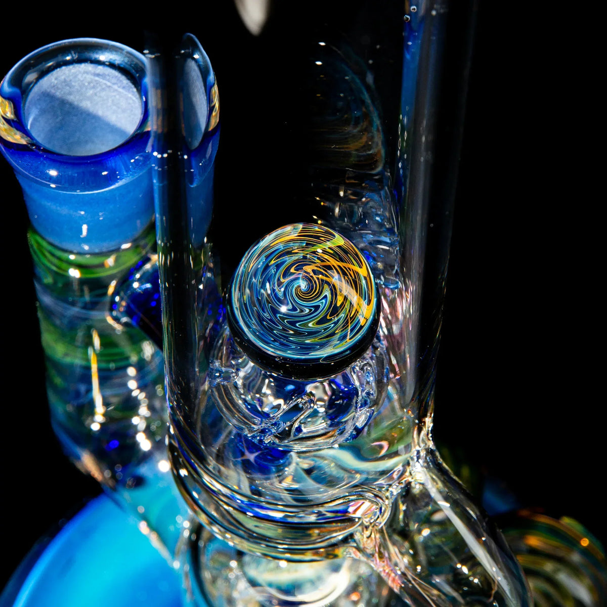Close-up of colorful heady glass water pipe with vibrant swirl marble accents