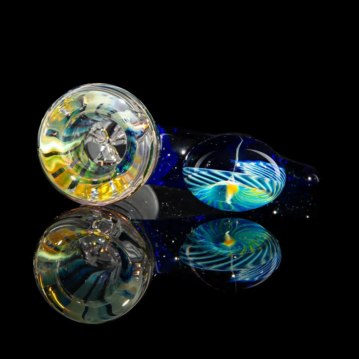 Handcrafted glass pipe with colorful swirl design on black reflective surface