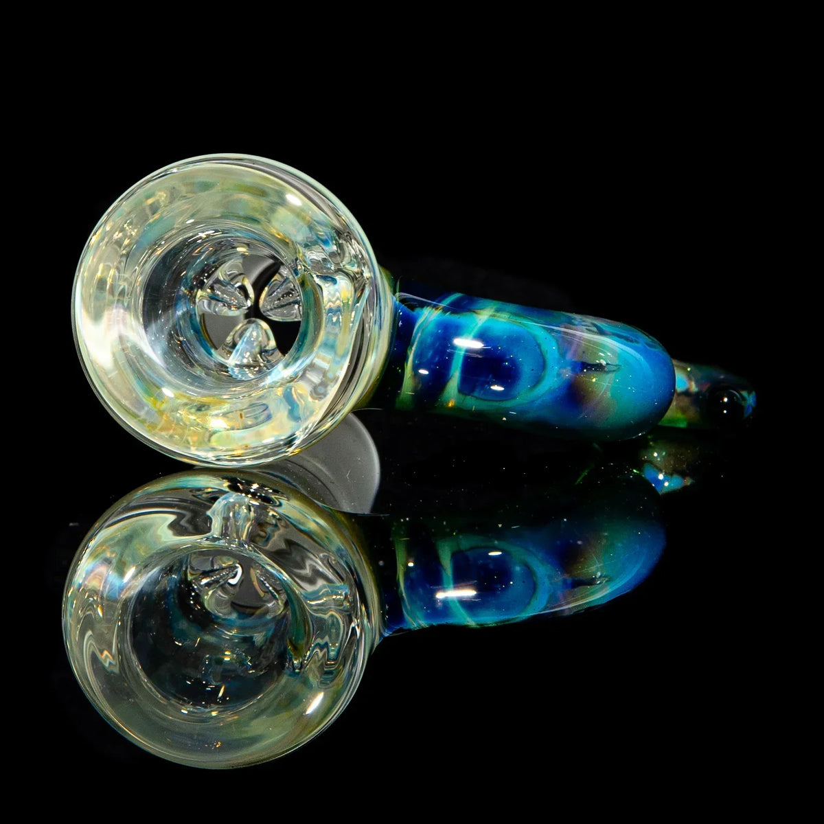 Colorful glass hand pipe with blue and green swirls, displayed on reflective black surface