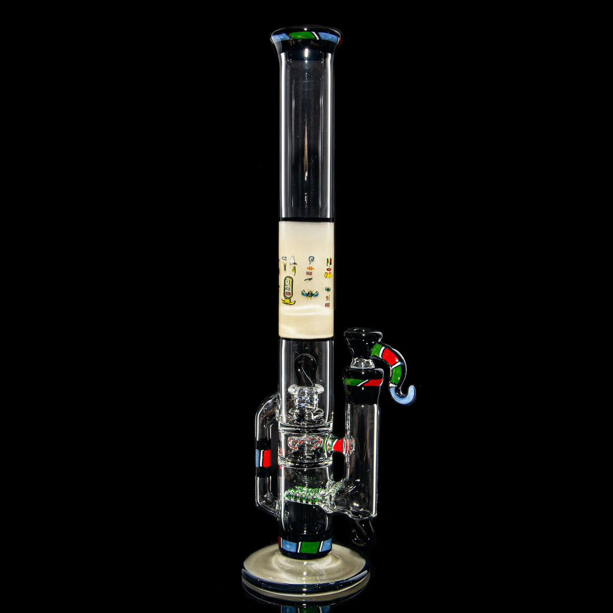 Heady glass water pipe with vibrant colored accents on a black background