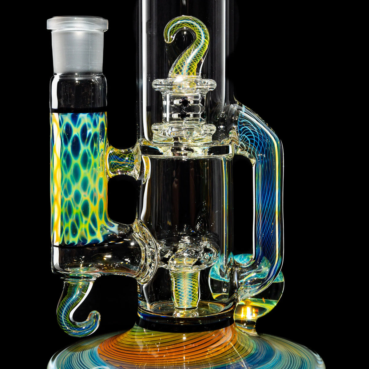 Colorful heady glass water pipe with intricate patterns and curved details on black background