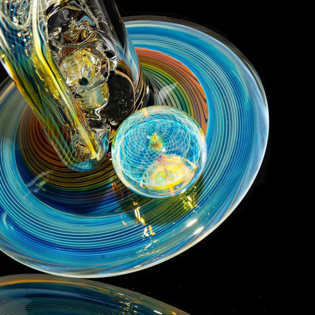 Heady glass water pipe base with swirling blue, yellow, and orange colors and marble accent